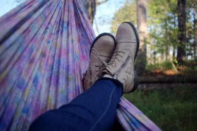 Ways to practice self-care - girl laying in hammock