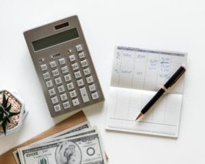Health and Wellness Certification Cost - white table with calculator, $100 bills, checkbook