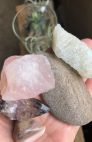A person is holding crystals such as rose quartz. Next-Level Self-Care.